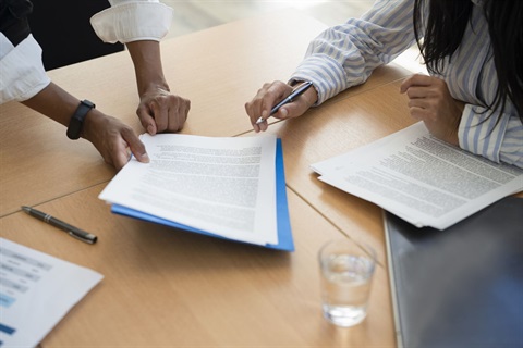 Photo of two people reviewing paperwork