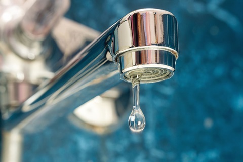 Photo of a faucet dripping water