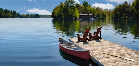 Photo on the Lake with two chairs and a boat