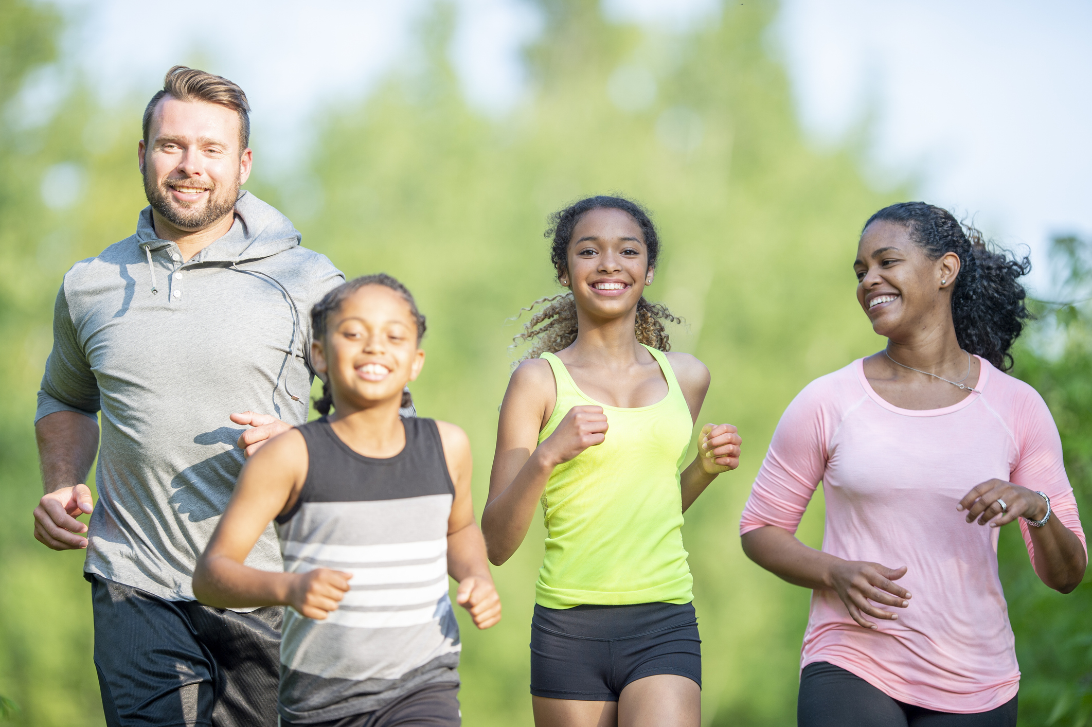 Photo of a family of four running