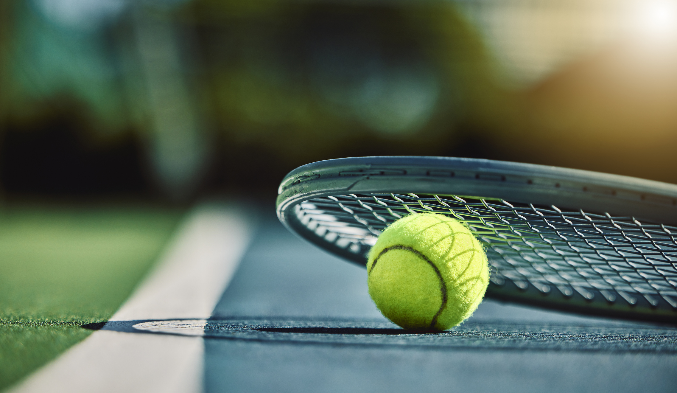 Photo of a tennis racket and ball